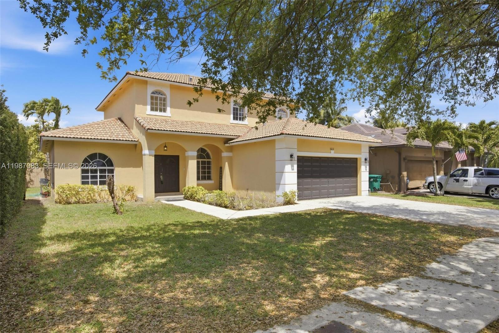 16131 Southwest 151st Terrace Miami, FL 33196 - Photo 2 of 55 a front view of a house with a garden and yard