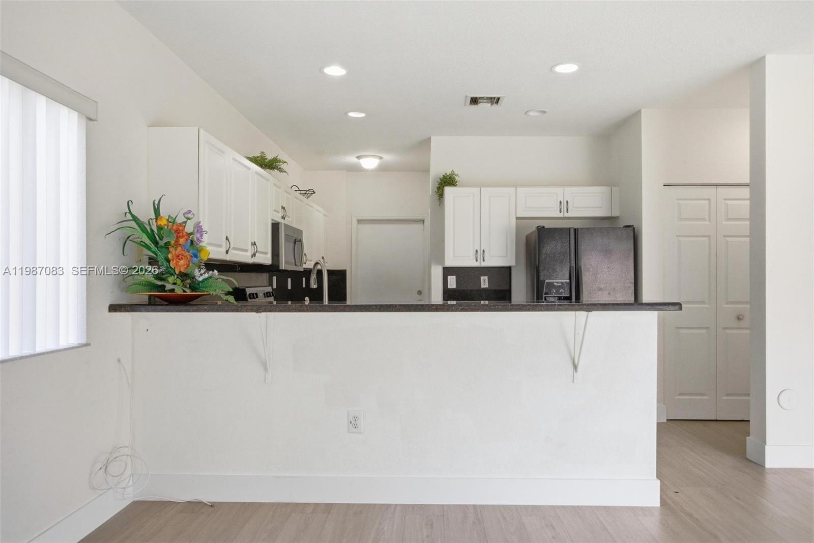 16131 Southwest 151st Terrace Miami, FL 33196 - Photo 23 of 55 a view of kitchen with stainless steel appliances a refrigerator a sink a stove a microwave and cabinets