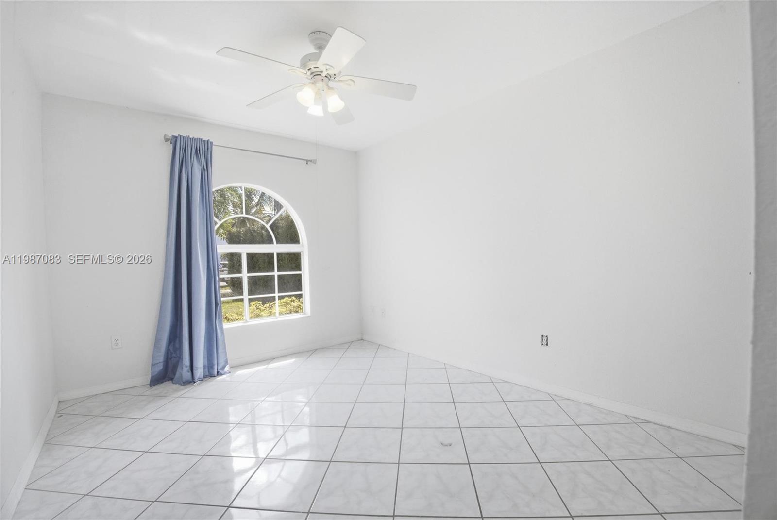 16131 Southwest 151st Terrace Miami, FL 33196 - Photo 29 of 55 an empty room with windows and ceiling fan
