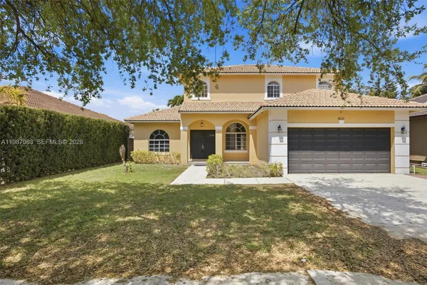 a front view of a house with a yard