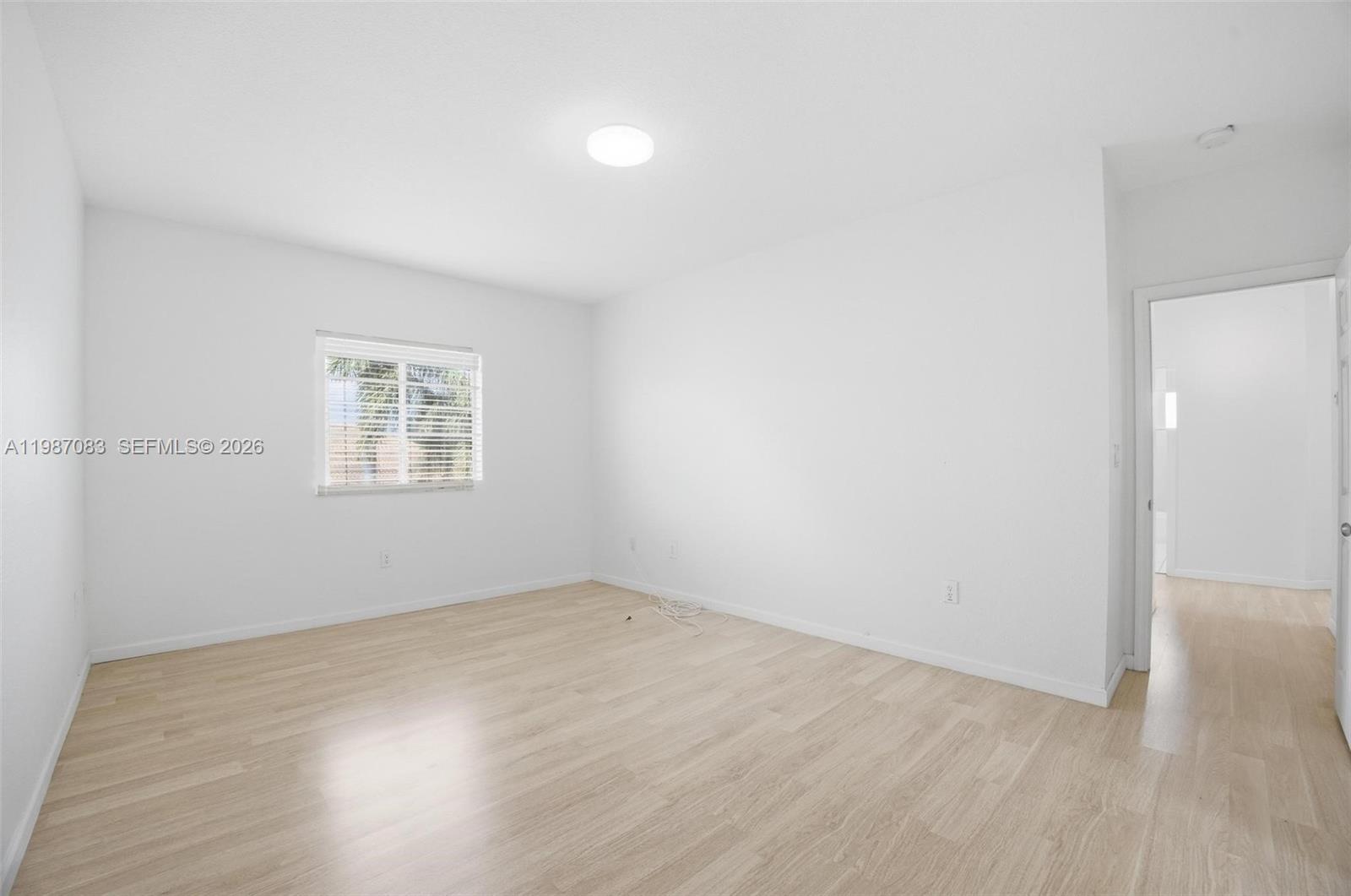 16131 Southwest 151st Terrace Miami, FL 33196 - Photo 42 of 55 an empty room with wooden floor and windows