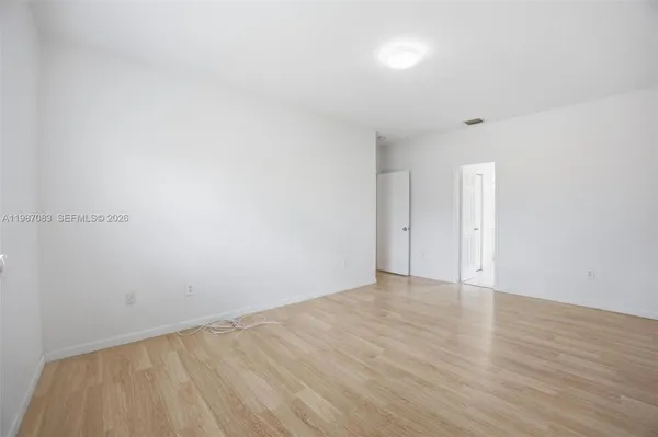 a bedroom with bed and window