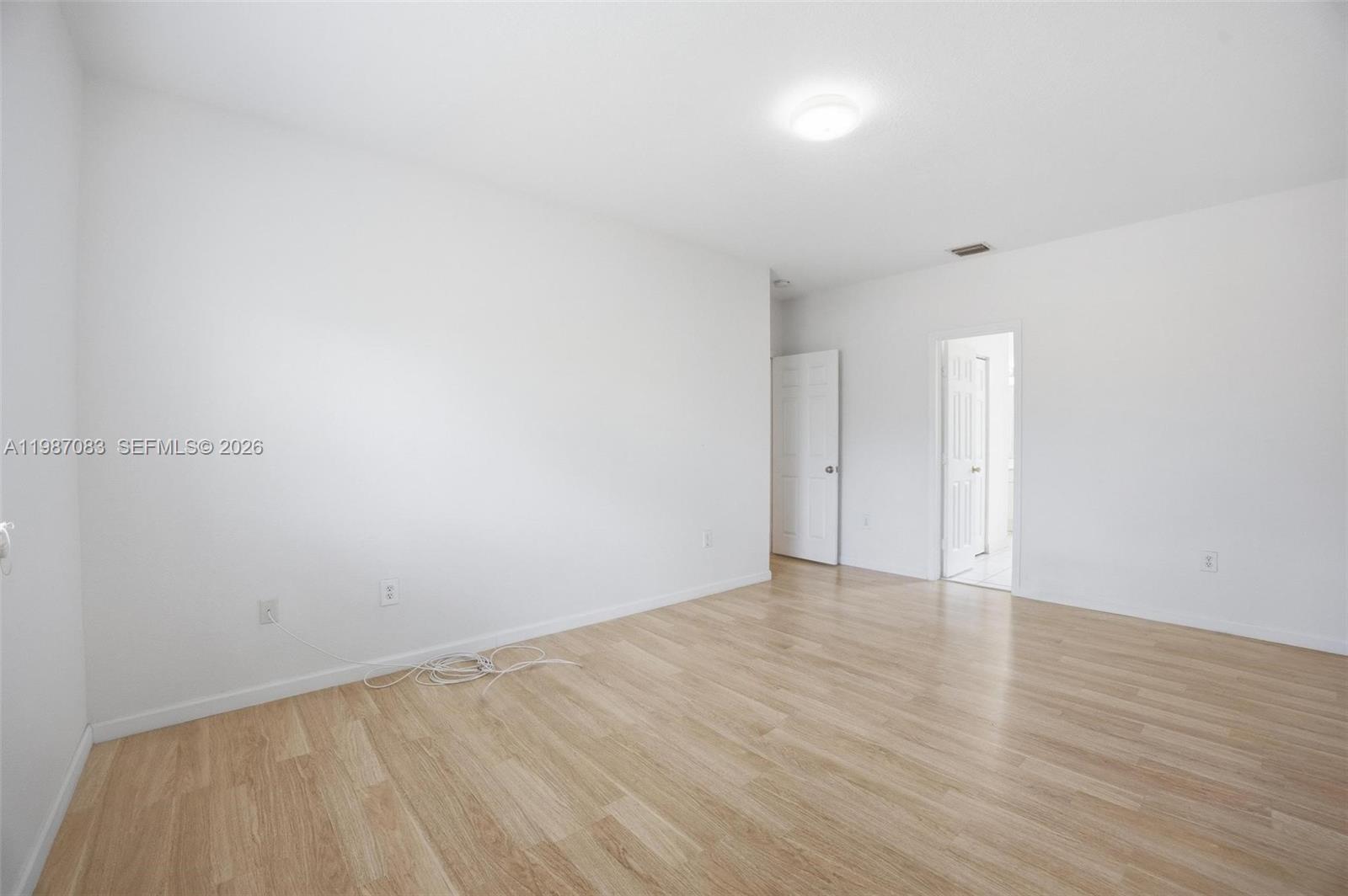 16131 Southwest 151st Terrace Miami, FL 33196 - Photo 43 of 55 a view of an empty room with wooden floor