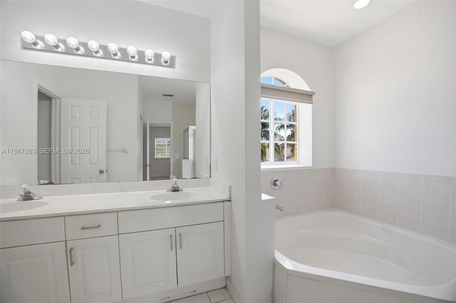 16131 Southwest 151st Terrace Miami, FL 33196 - Photo 44 of 55 a bathroom with a sink tub and a mirror