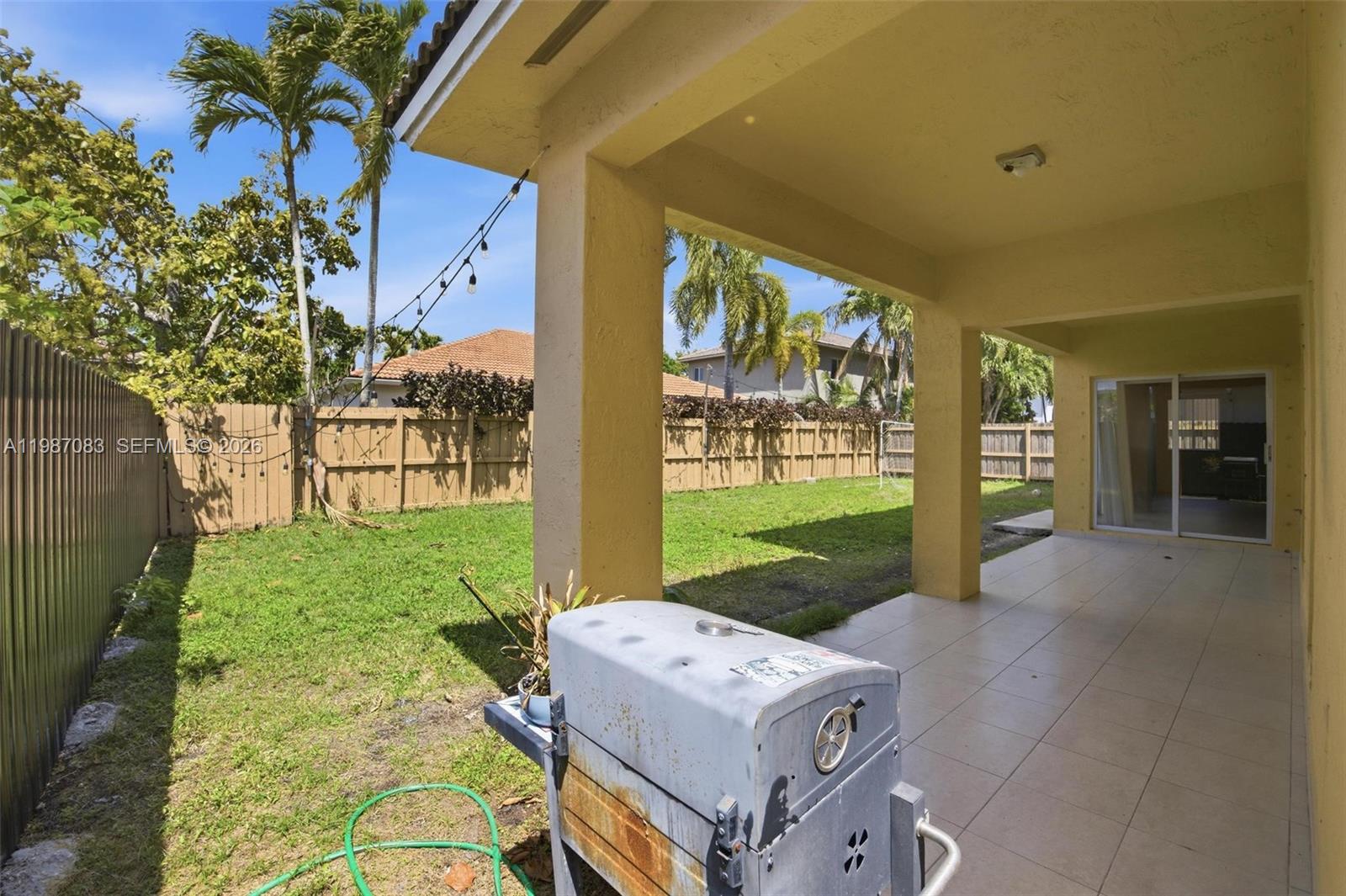16131 Southwest 151st Terrace Miami, FL 33196 - Photo 7 of 55 a view of a porch with furniture and garden
