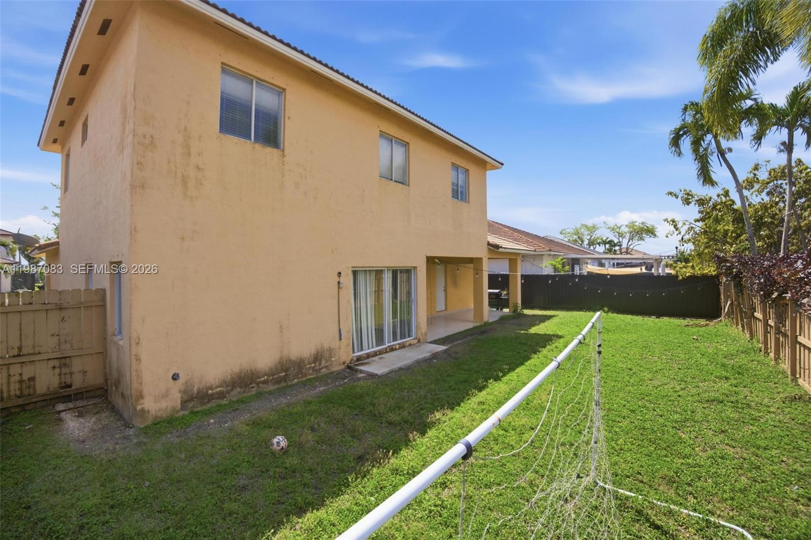 16131 Southwest 151st Terrace Miami, FL 33196 - Photo 10 of 55 a backyard of a house with plants and a lawn chairs
