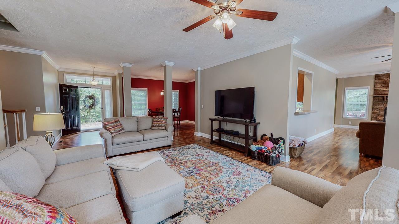 125 Adams Farm Road Roxboro, NC 27574 - Photo 11 of 30 a living room with furniture and a flat screen tv