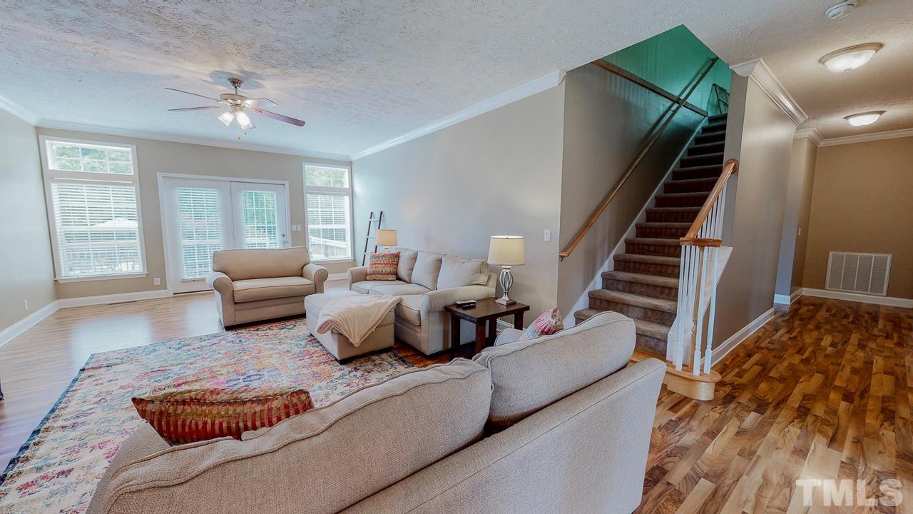 125 Adams Farm Road Roxboro, NC 27574 - Photo 12 of 30 a living room with furniture and a chandelier