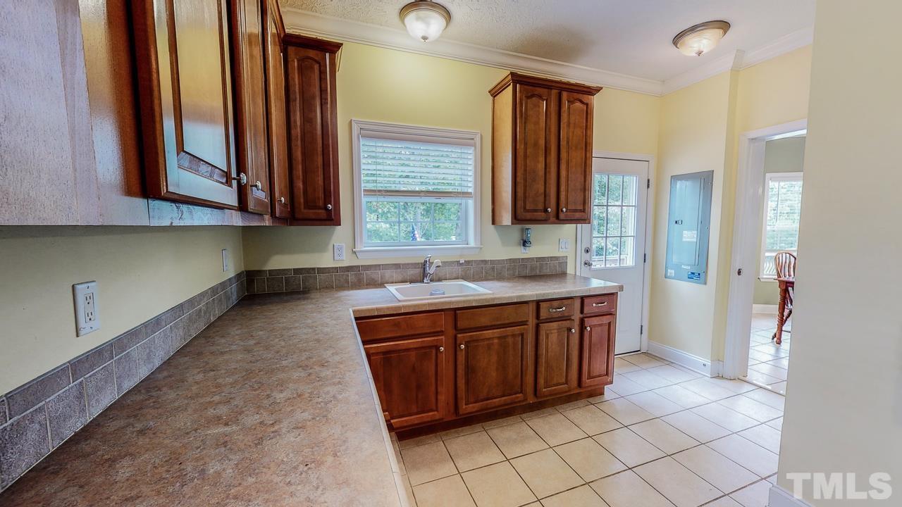 125 Adams Farm Road Roxboro, NC 27574 - Photo 16 of 30 a large bathroom with a granite countertop sink and a mirror