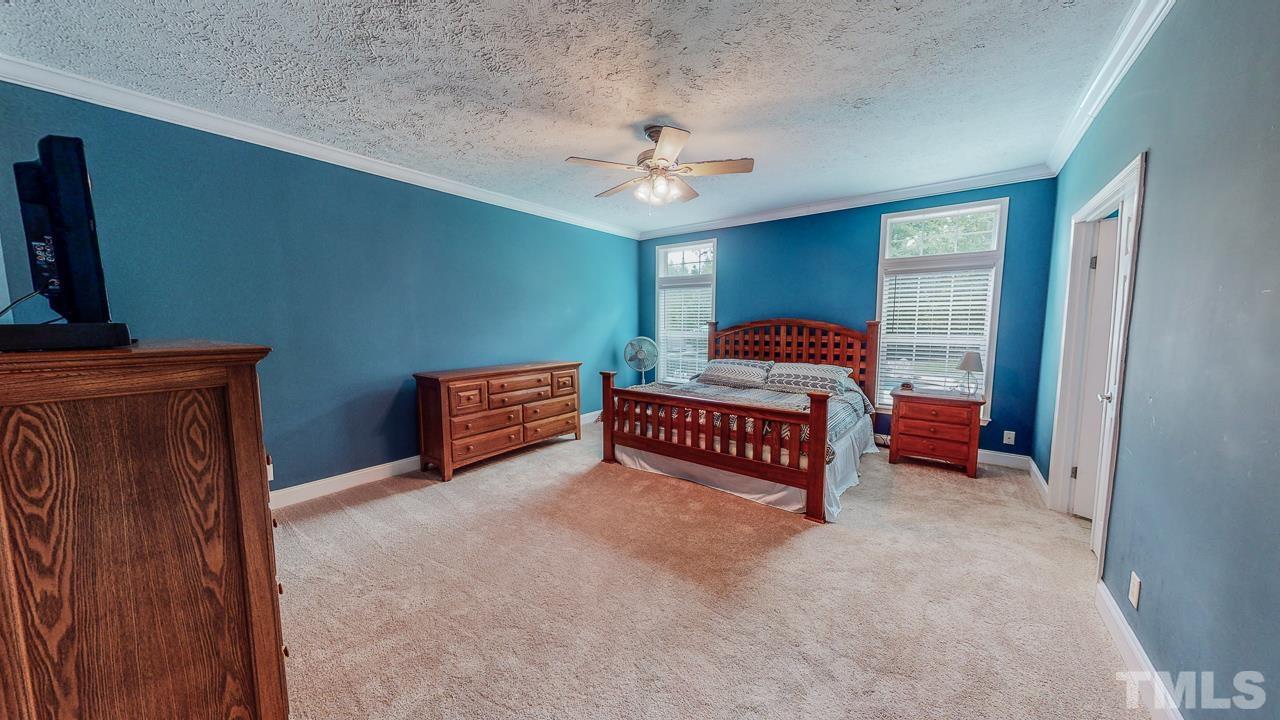 125 Adams Farm Road Roxboro, NC 27574 - Photo 19 of 30 a bedroom with furniture and a chandelier