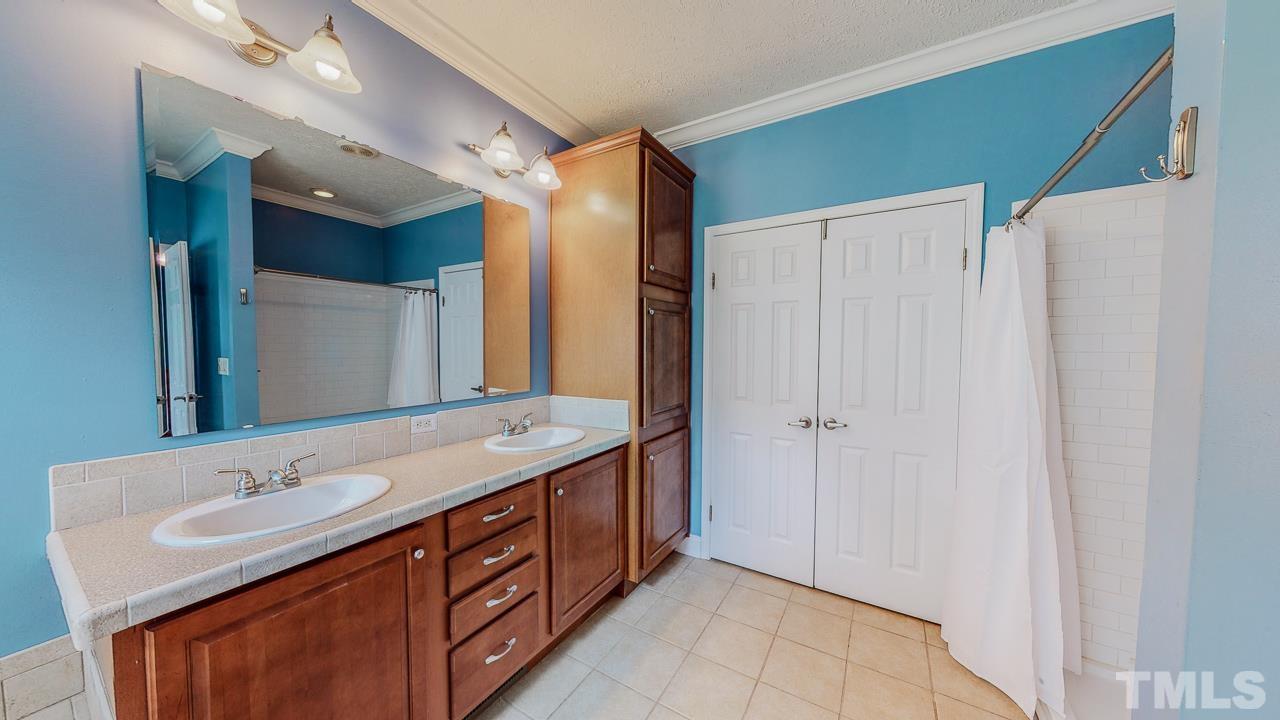 125 Adams Farm Road Roxboro, NC 27574 - Photo 20 of 30 a bathroom with a double vanity sink and mirror