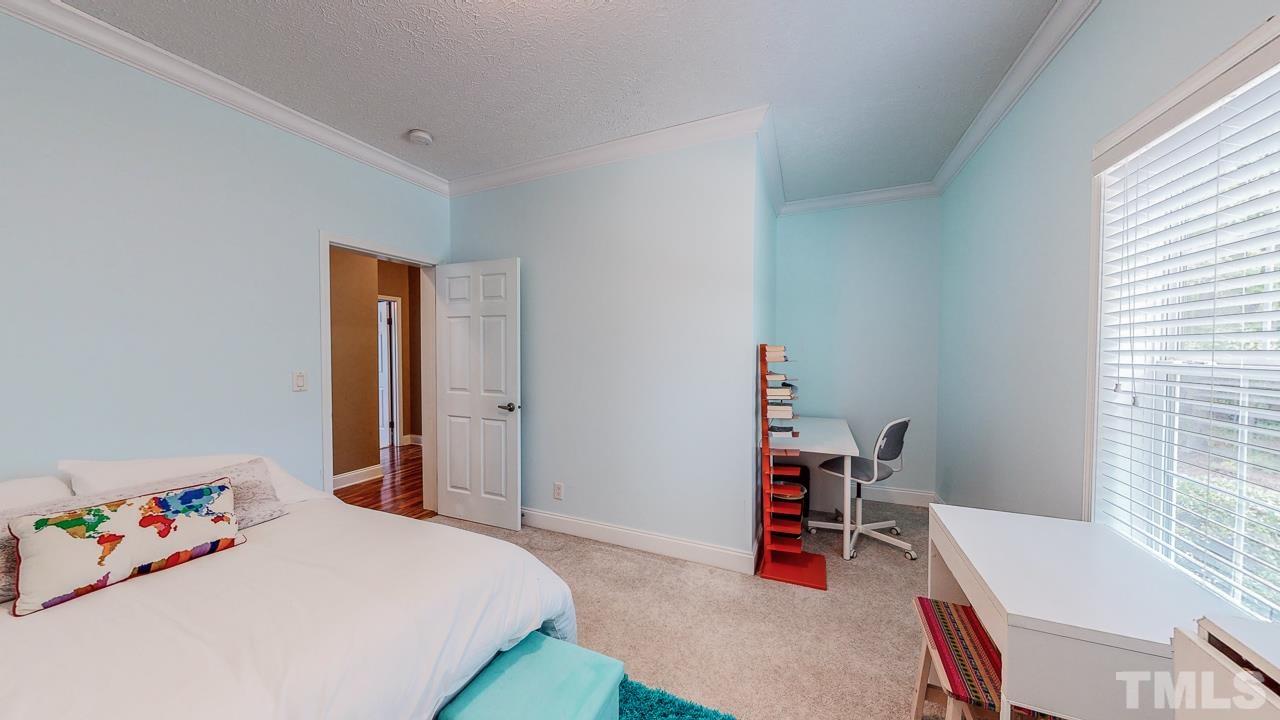 125 Adams Farm Road Roxboro, NC 27574 - Photo 21 of 30 a bedroom with a bed and a desk