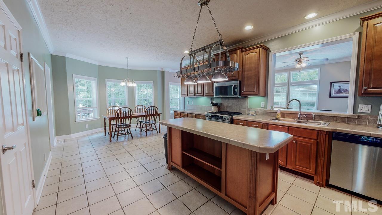 125 Adams Farm Road Roxboro, NC 27574 - Photo 5 of 30 a kitchen with stainless steel appliances granite countertop a sink and a counter space