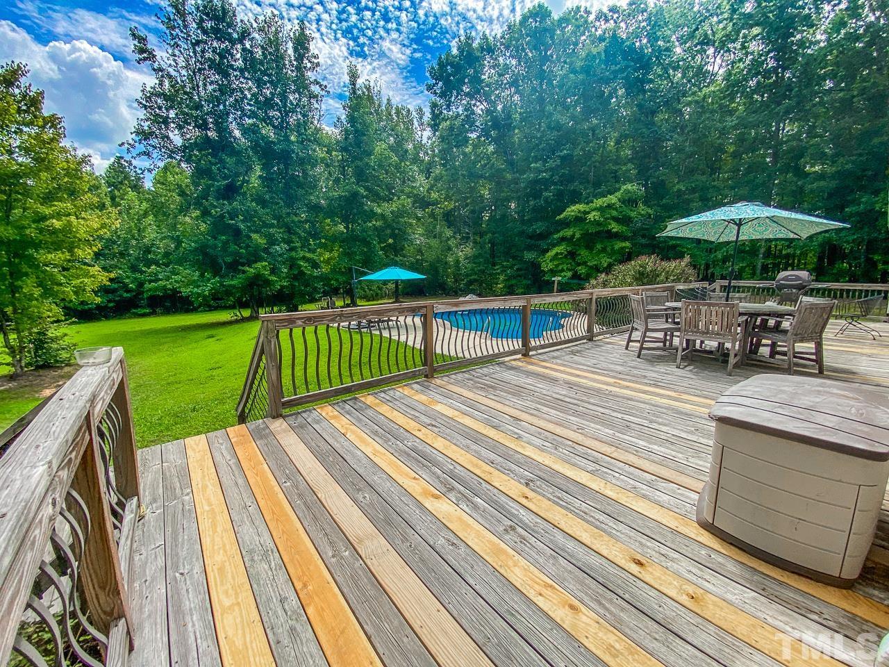 125 Adams Farm Road Roxboro, NC 27574 - Photo 9 of 30 a view of backyard with swimming pool and outdoor seating