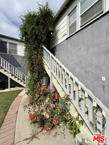 a balcony with flowers in front of it