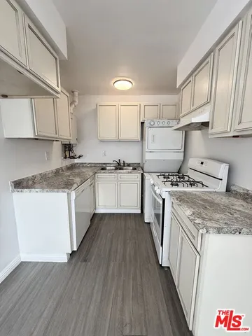 a kitchen with a stove a sink and a refrigerator