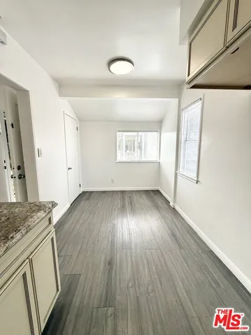 a view of a kitchen and wooden floor