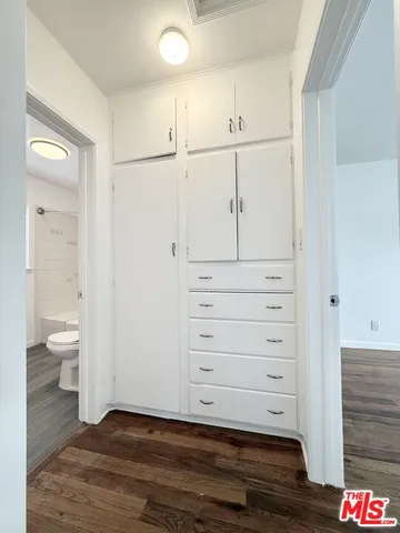 a view of a hallway with white doors