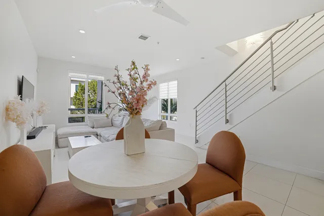 a living room with furniture flowerpot and wooden floor