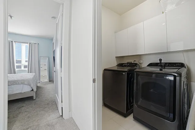 a living room with furniture gym equipment and a large window