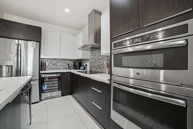 a kitchen with granite countertop stainless steel appliances and wooden cabinets