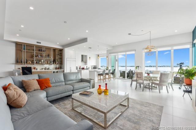 a living room with lots of furniture and kitchen view