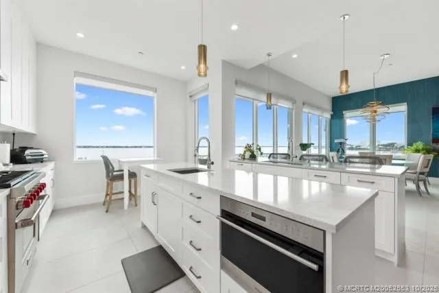 a large kitchen with stainless steel appliances lots of counter space and breakfast area