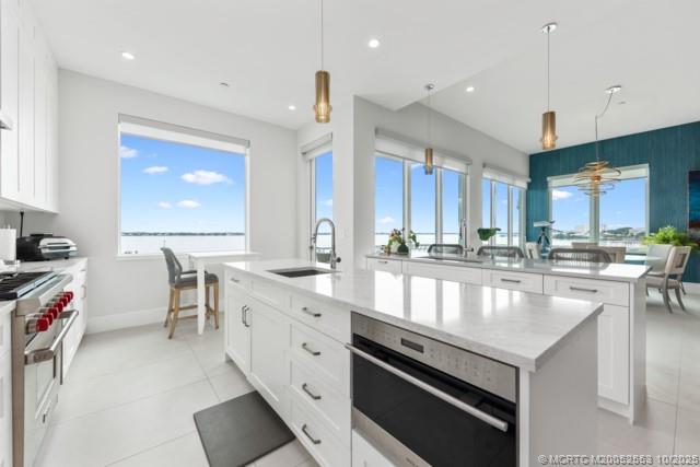 51 Southeast Seminole Street, Unit 305 Stuart, FL 34994 - Photo 14 of 47 a large kitchen with stainless steel appliances lots of counter space and breakfast area