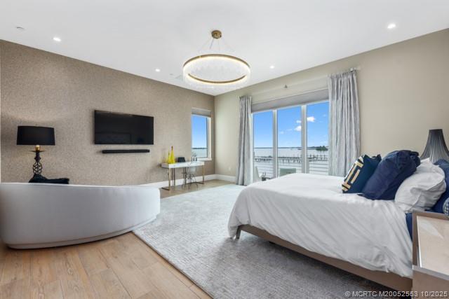 51 Southeast Seminole Street, Unit 305 Stuart, FL 34994 - Photo 22 of 47 a bedroom with a bed and a flat screen tv