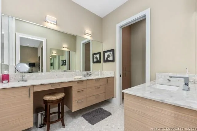 a bathroom with a granite countertop double vanity sink a mirror and a shower