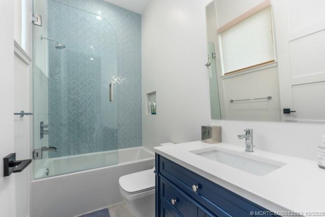 51 Southeast Seminole Street, Unit 305 Stuart, FL 34994 - Photo 32 of 47 a bathroom with a granite countertop bathtub shower sink vanity mirror and toilet