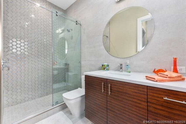 51 Southeast Seminole Street, Unit 305 Stuart, FL 34994 - Photo 34 of 47 a spacious bathroom with a granite countertop sink toilet and shower