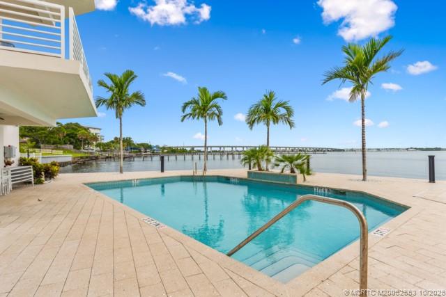 51 Southeast Seminole Street, Unit 305 Stuart, FL 34994 - Photo 38 of 47 a view of a swimming pool with a table and chairs