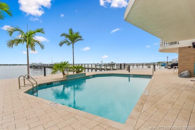 51 Southeast Seminole Street, Unit 305 Stuart, FL 34994 - Photo 39 of 47 a view of a swimming pool and an outdoor seating
