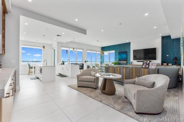 51 Southeast Seminole Street, Unit 305 Stuart, FL 34994 - Photo 9 of 47 a living room with furniture and a view of kitchen
