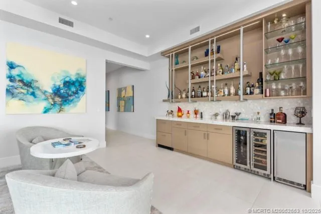 a kitchen with granite countertop a white cabinets and chairs