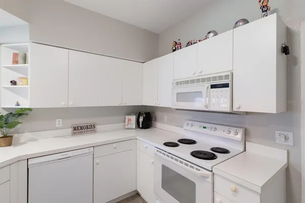 a kitchen with a stove and a white refrigerator