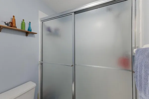 a bathroom with a glass shower door