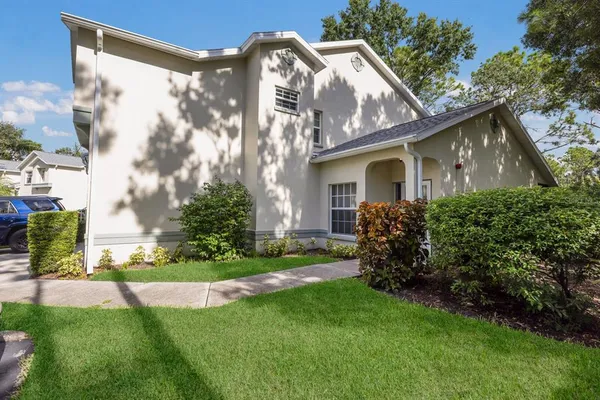 a front view of house with yard and green space