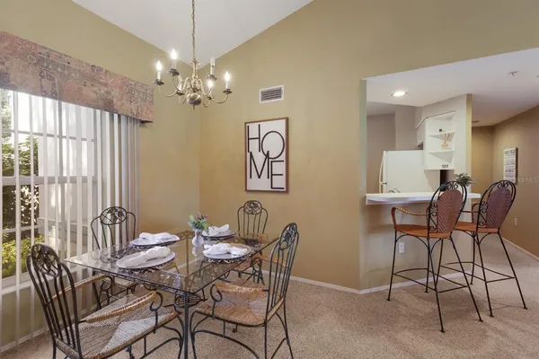a view of a dining room with furniture and a chandelier