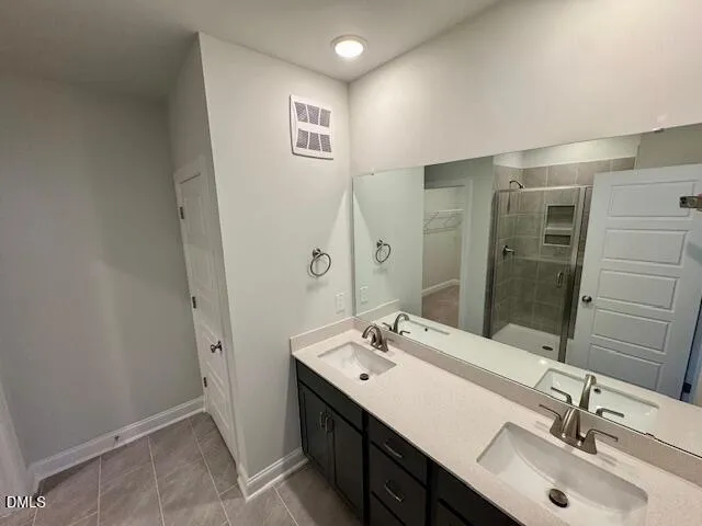 a bathroom with a double vanity sink mirror and