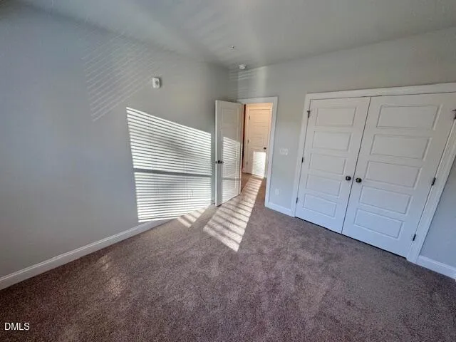 a view of an empty room with a fireplace