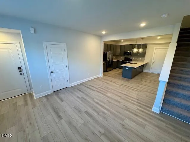 a view of a room with wooden floor and furniture