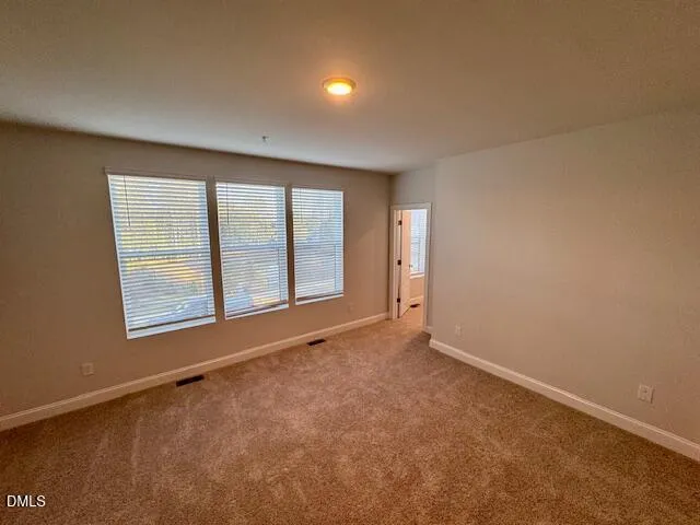 an empty room with a empty space and windows