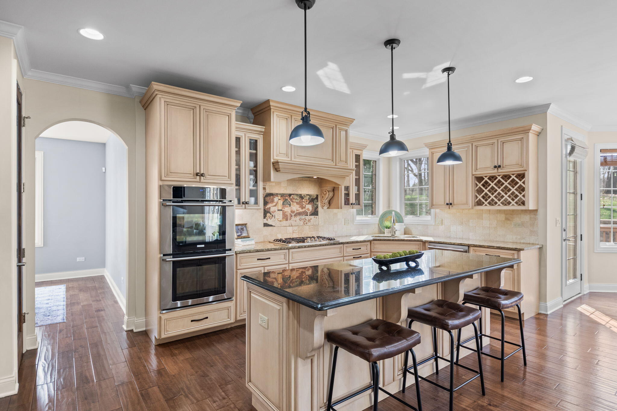 9080 Winding Trail St. John, IN 46373 - Photo 12 of 34 a kitchen with stainless steel appliances kitchen island granite countertop a stove a sink and a refrigerator