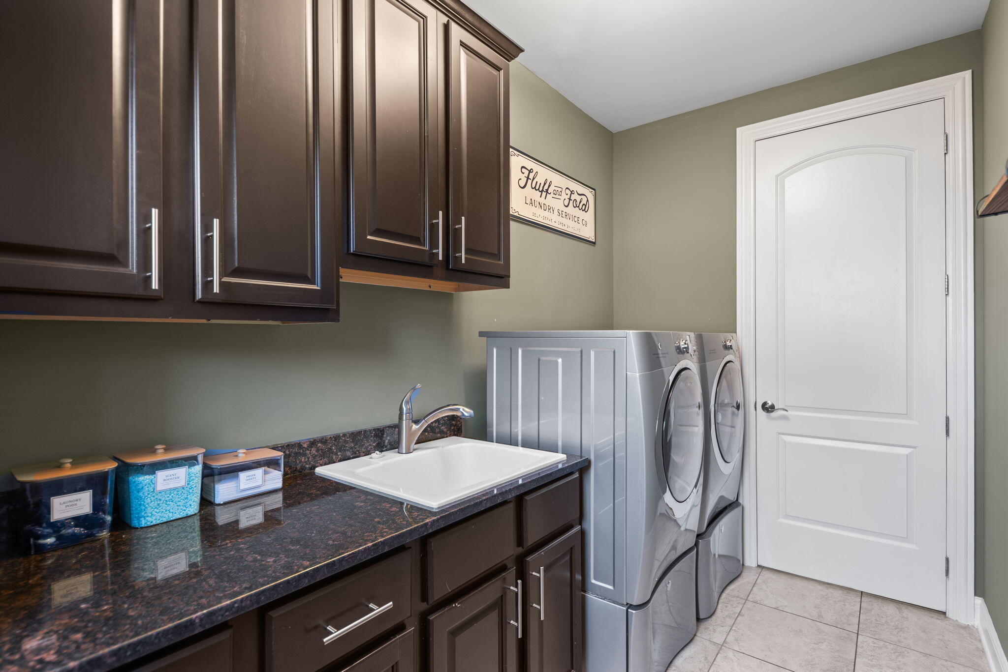 9080 Winding Trail St. John, IN 46373 - Photo 32 of 34 a kitchen with stainless steel appliances granite countertop a refrigerator a sink and wooden cabinets