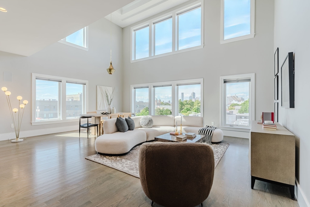 247 D Street, Unit 8 Boston, MA 02127 - Photo 1 of 42 a living room with furniture and a large window