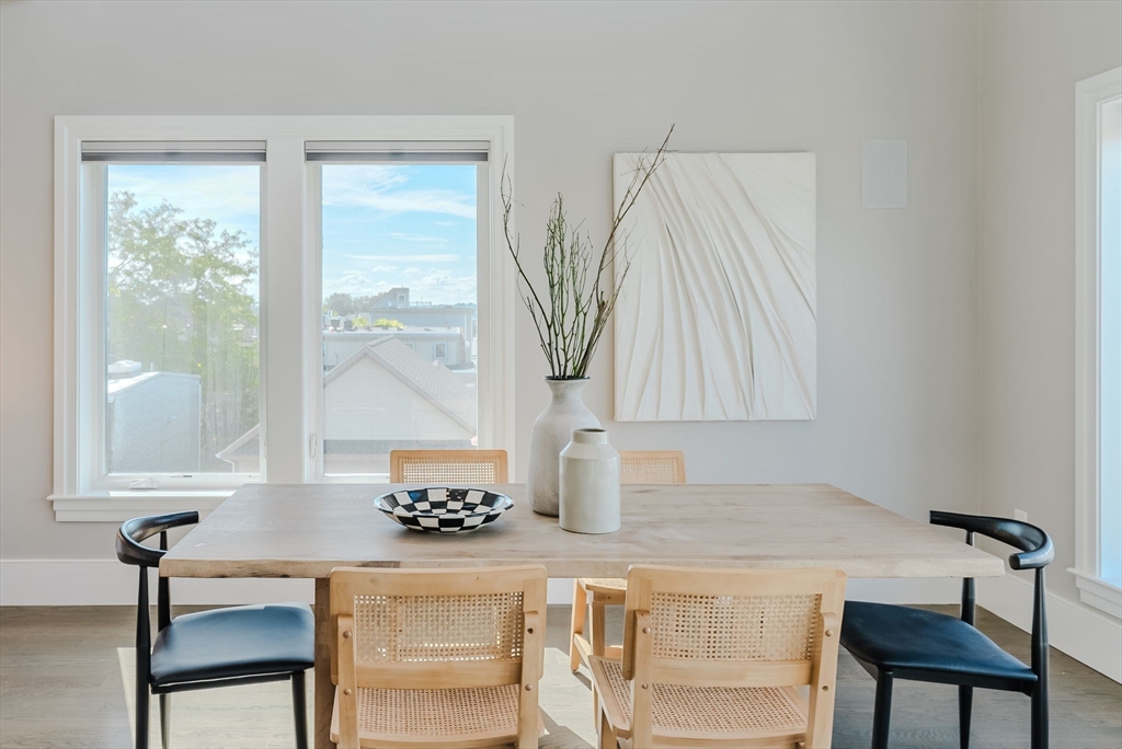247 D Street, Unit 8 Boston, MA 02127 - Photo 13 of 42 a living room with a table and a large window