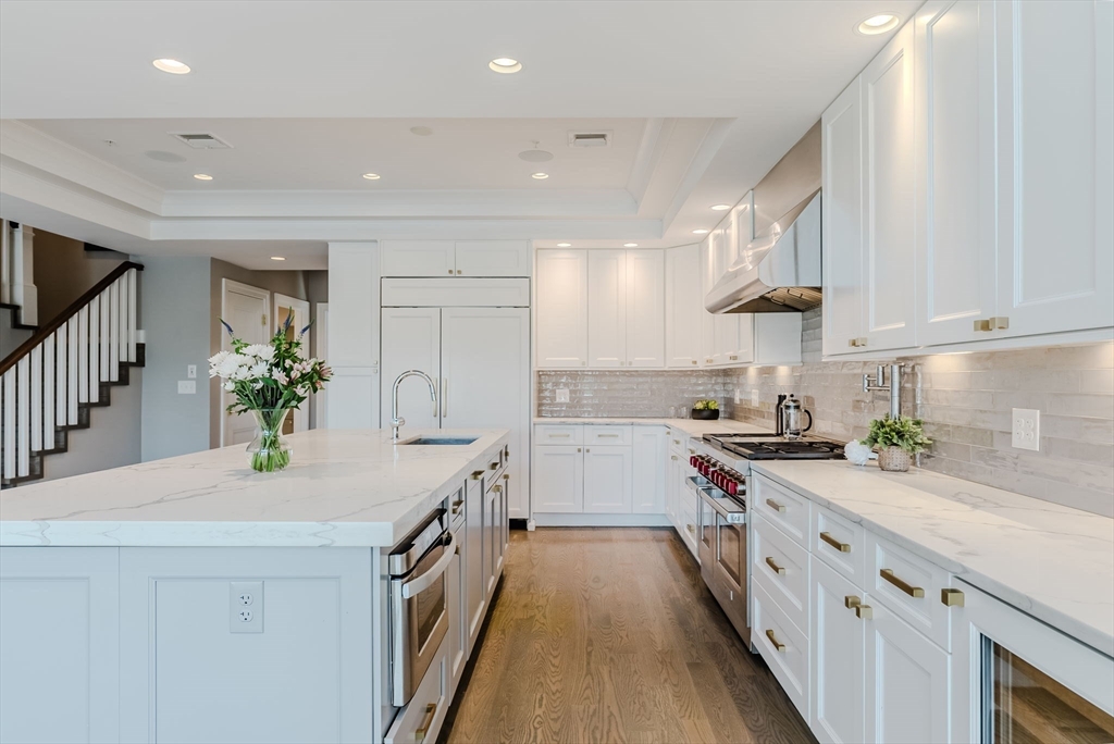 247 D Street, Unit 8 Boston, MA 02127 - Photo 15 of 42 a kitchen with stainless steel appliances granite countertop a sink a stove and a refrigerator