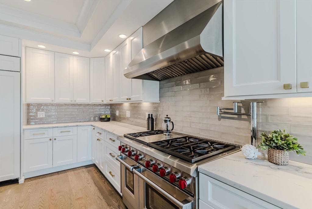 247 D Street, Unit 8 Boston, MA 02127 - Photo 16 of 42 a kitchen with a stove and a white cabinets